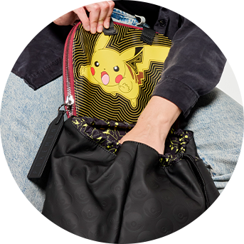 Model showcasing Loungefly COLLECTIV Pok&eacute;mon The COLLECTR Full-Size Backpack hidden pocket